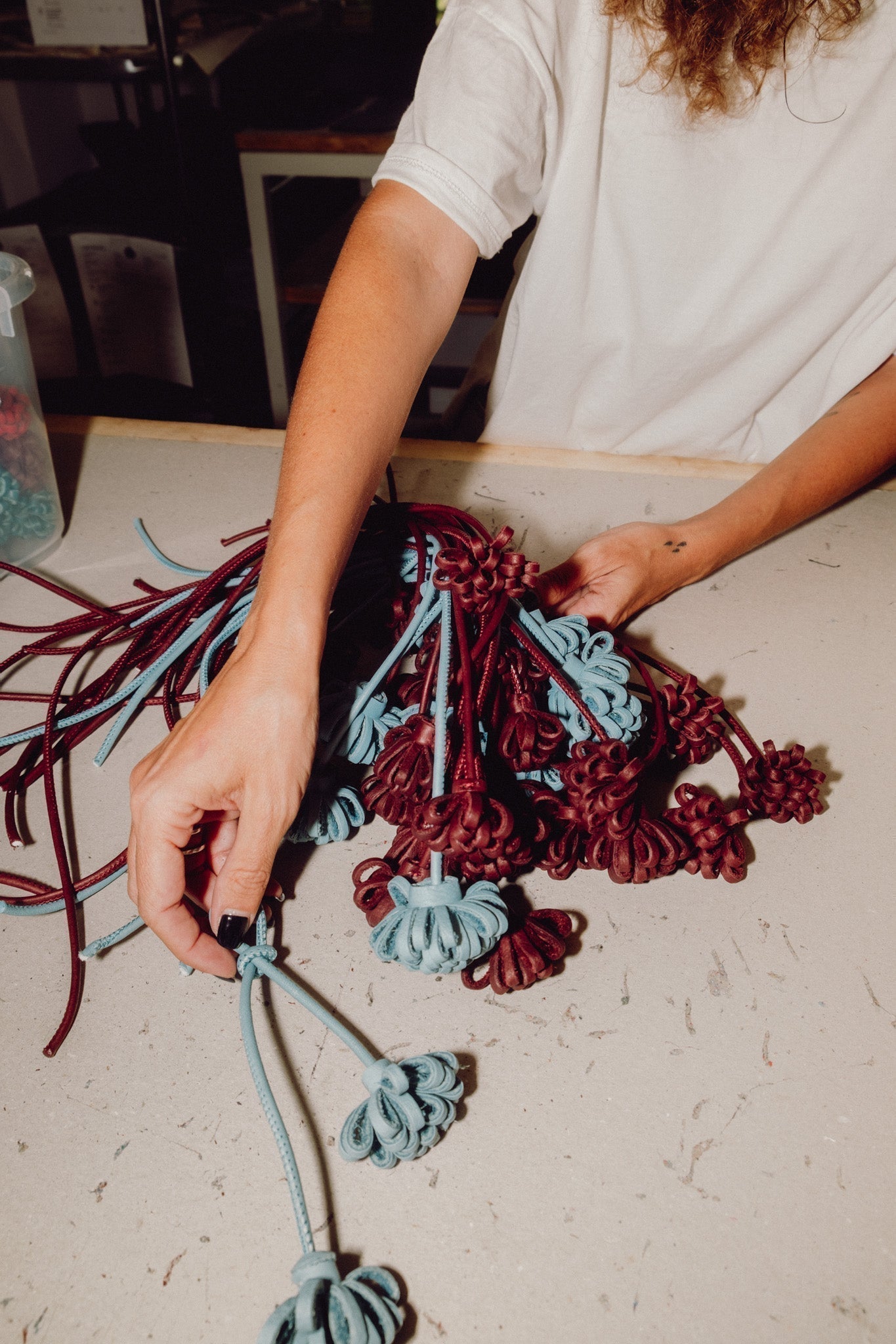 Manos trabajando flores de piel en el taller de Labienhecha